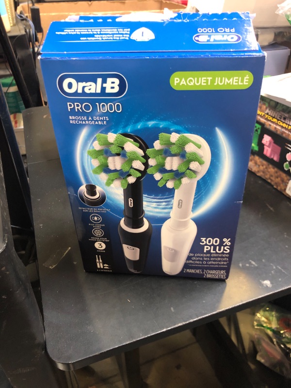 Photo 1 of Oral-B Pro 1000 CrossAction Electric Toothbrush, Black and White, 2 Count