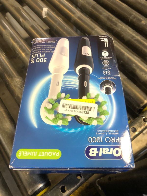 Photo 1 of Oral-B Pro 1000 CrossAction Electric Toothbrush, Black and White, 2 Count