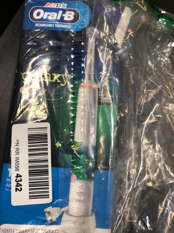 Photo 1 of Oral-B Kids Electric Toothbrush with Coaching Pressure Sensor and Timer, Rechargeable Toothbrush with Brush Heads, Galaxy