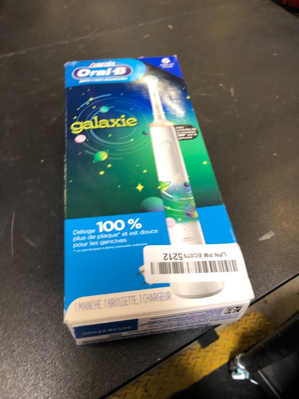 Photo 1 of Oral-B Kids Electric Toothbrush with Coaching Pressure Sensor and Timer, Rechargeable Toothbrush with Brush Heads, Galaxy
