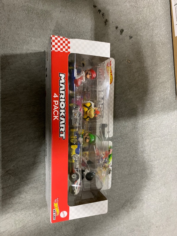 Photo 1 of Hot Wheels Mario Kart Set of 4 Die-Cast Toy Cars with Attached Character Drivers, Includes Black Yoshi (Amazon Exclusive)