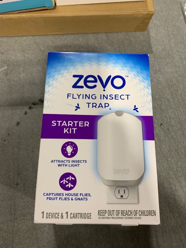 Photo 1 of Zevo Flying Insect Trap & Cartridge - Plug in Fly Trap & Indoor Bug Catcher for Gnats, House & Fruit Flies - Mess-Free - Use in Any Room - Uses Blue & UV Light (1 Plug in Device & 1 Cartridge)
