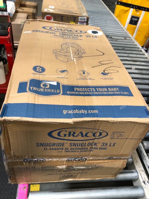 Photo 1 of **OPENED IN NELLIS WAREHOUSE**
Graco SnugRide SnugLock LX Car Seat featuring TrueShield Technology