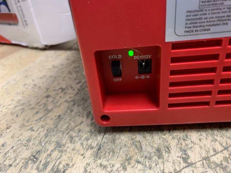 Photo 1 of Frigidaire Red Mini Personal Fridge Cooler, 1 Gal Capacity fits Six Cans, Includes Plugs for Home Outlet & DC Charger - 9.84" D x 7.09" W x 10.35" H
