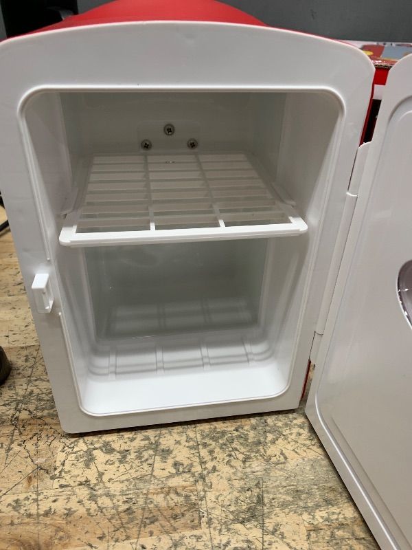 Photo 1 of Frigidaire Red Mini Personal Fridge Cooler, 1 Gal Capacity fits Six Cans, Includes Plugs for Home Outlet & DC Charger - 9.84" D x 7.09" W x 10.35" H