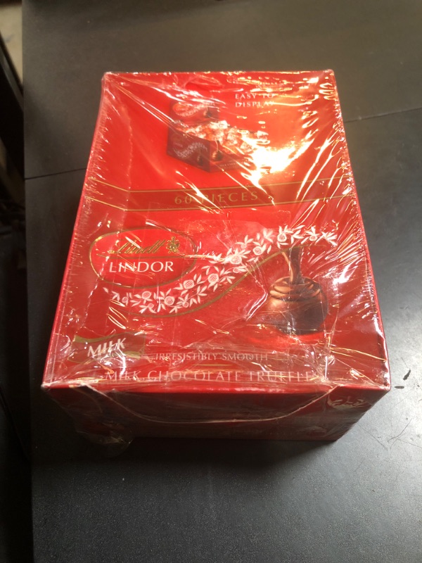 Photo 1 of Lindt LINDOR Milk Chocolate Candy Truffles, Milk Chocolate with Smooth, Melting Truffle Center, 25.4 oz., 60 Count (BB 10/31/25)