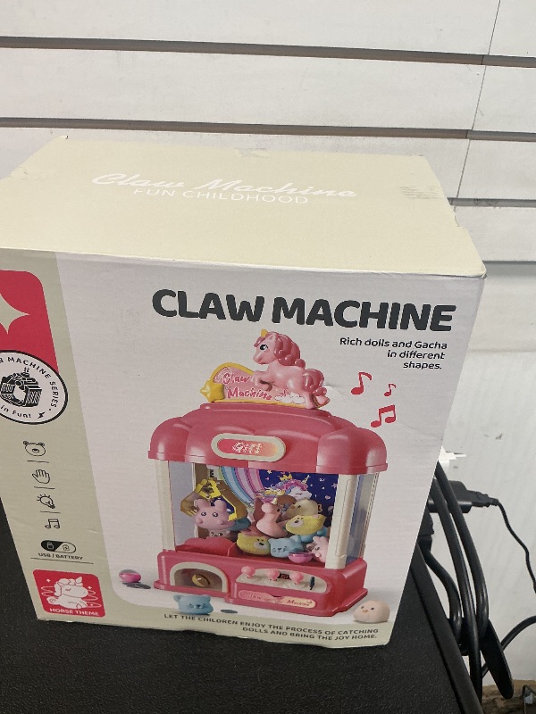 Photo 1 of AIQI 60 PCS Unicorn Kids Claw Machine, Vending Claw Machine with Lights Sound, Candy and Prize Electronic Dispenser Game Toys for Kids, Claw Machine Toys for 3 4 5 6 7 8 Years Old Girls