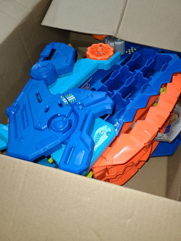 Photo 1 of Hot Wheels City Toy Car Track Set, Ultimate T-Rex Transporter, Dinosaur Hauler for 20+ Vehicles, Semi Transforms into Dino with Lights & Sounds