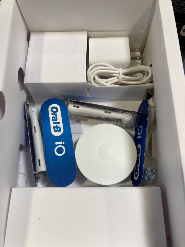 Photo 1 of Oral-B iO Series 10 Rechargeable Electric Toothbrush with Visible Pressure Sensor to Protect Gums, 2 Min Timer, 7 Cleaning Settings, 4 Replacement Toothbrush Heads, and Charging Travel Case, White