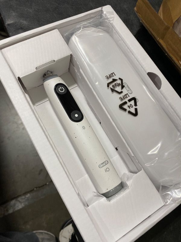 Photo 1 of Oral-B iO Series 10 Rechargeable Electric Toothbrush with Visible Pressure Sensor to Protect Gums, 2 Min Timer, 7 Cleaning Settings, 4 Replacement Toothbrush Heads, and Charging Travel Case, White