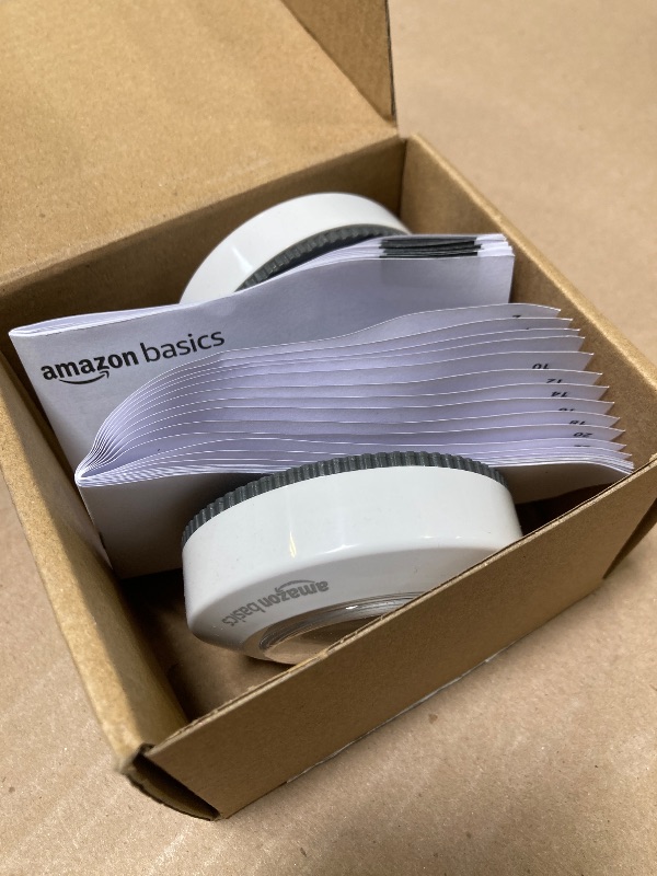 Photo 1 of Amazon Basics LED Puck Lights, Battery Operated, 50 Lumens 2 Pack, Tap Light, Stick on Lights, Under Cabinet Lighting, Ideal for Kitchen Cabinets, Closets, Garage and More, White
