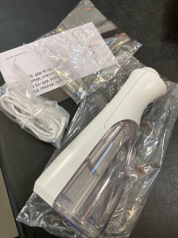 Photo 1 of Waterpik Cordless Pearl Rechargeable Portable Water Flosser for Teeth, Gums, Braces Care and Travel with 4 Flossing Tips - ADA Accepted, WF-13 White, Packaging May Vary