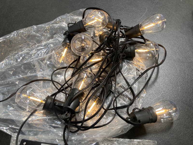 Photo 1 of Brightever Solar Powered Outdoor String Lights with Remote, 27FT Commercial Grade Waterproof Solar Patio Lights, 12+1 Shatterproof LED Bulbs 3 Lighting Modes, Dimmable Solar Lighting for Outside