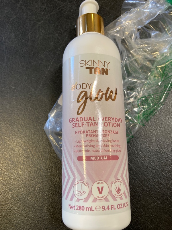 Photo 1 of Skinny Tan Body Glow Gradual Tan Lotion - Lightweight, Fast-Absorbing Formula - Coconut and Vanilla Scent - Enriched with Aloe Vera and Guarana - Natural, Streak Free Gold Color - Medium - 9.4 oz