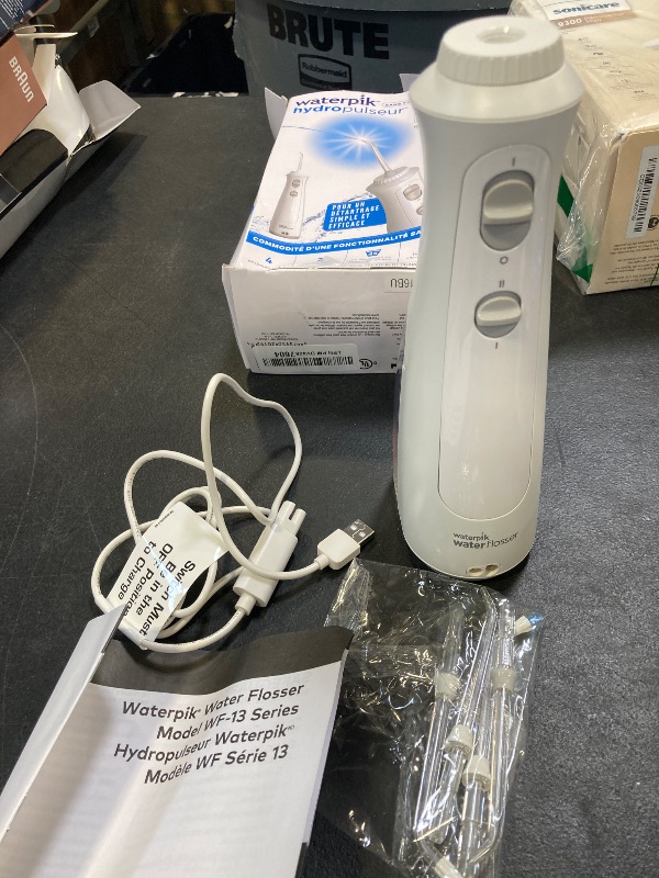 Photo 1 of Waterpik Cordless Pearl Rechargeable Portable Water Flosser for Teeth, Gums, Braces Care and Travel with 4 Flossing Tips - ADA Accepted, WF-13 White, Packaging May Vary