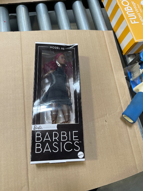 Photo 1 of Barbie Basics Model 03 Collector Doll with Red Curly Hair, Black Mini Dress & Boots, Universal-fit Fashions, Posable Tall Body & Swappable Doll Head