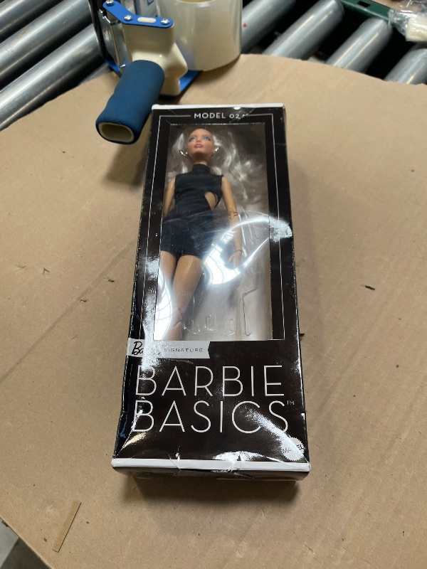 Photo 1 of Barbie Basics Model 02 Collector Doll with Blonde Hair, Black Mini Dress & Gladiator Boots, Universal-fit Fashions, Posable Body & Swappable Doll Head