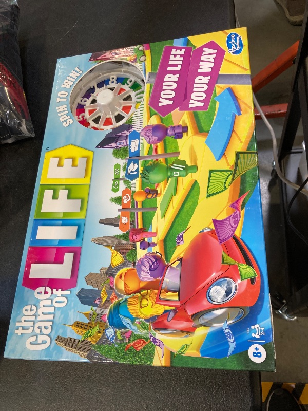 Photo 1 of The Game of Life Game, Family Board Game for 2-4 Players, Indoor Game for Kids Ages 8 and Up, Pegs Come in 6 Colors