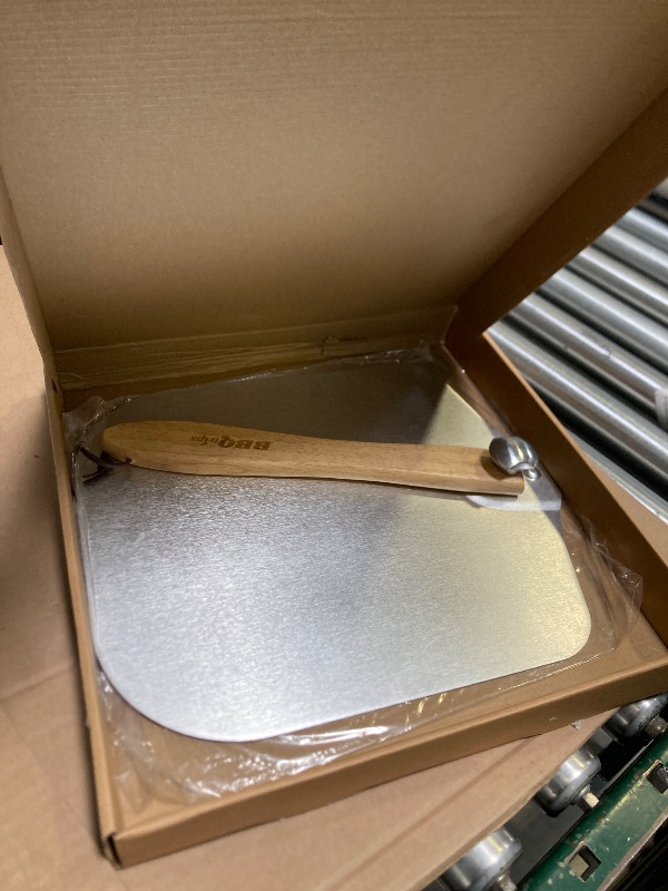 Photo 1 of 12 inch aluminum pizza paddle with swing handle - perfect for home ovens, pizza pans, and pizza ovens - ideal for pizza lovers and chefs.