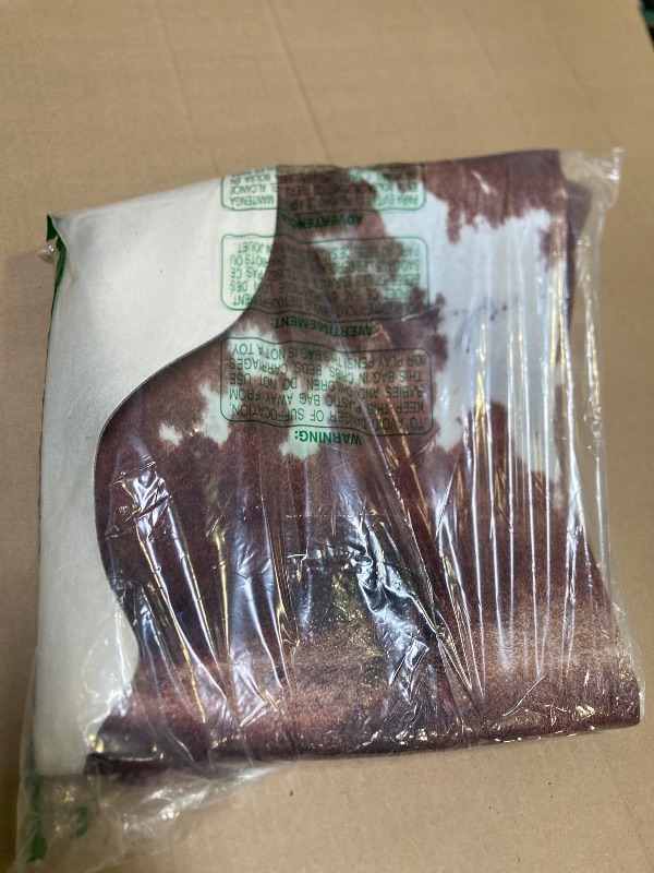 Photo 1 of WARM HAVEN Cow Hide Faux Cowhide Rug: Cow Print Rug for Living Room Bedroom 4.6x5.2 Feet - Animal Print Skin Black and Brown Western