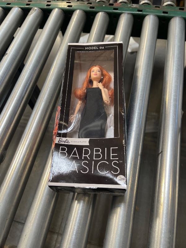Photo 1 of Barbie Basics Model 04 Collector Doll with Red Curly Hair, Black Mini Dress & Boots, Universal-fit Fashions, Posable Petite Body & Swappable Doll Head