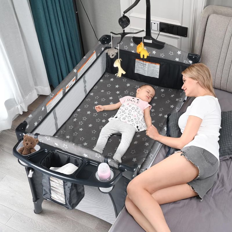 Photo 1 of Bedside Bassinet for Baby, Portable Baby Crib with Mosquito Net, Mattress, Diaper Changer, Playpen for Newborn to Toddles, Pack and Play with Bassinet, 5 in 1 Bedside Crib