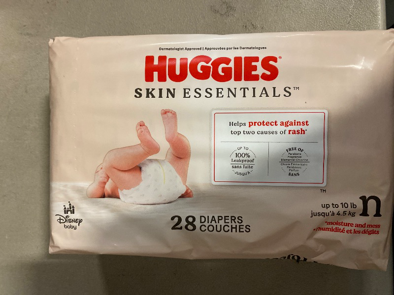 Photo 1 of Huggies Size Newborn Diapers, Skin Essentials Baby Diapers, Size Newborn (6-9 lbs), 28 Count, Packaging May Vary