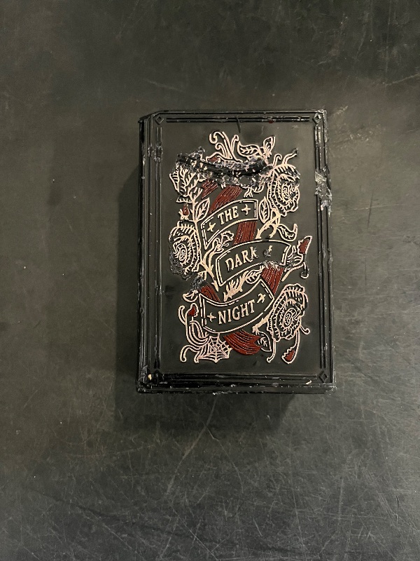 Photo 1 of threshold target book of spells gothic witch in the dark of night, black candle