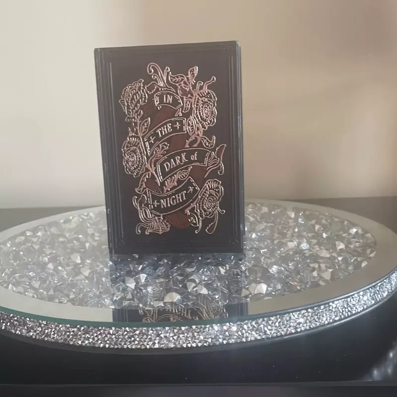 Photo 1 of threshold target book of spells gothic witch in the dark of night, black candle