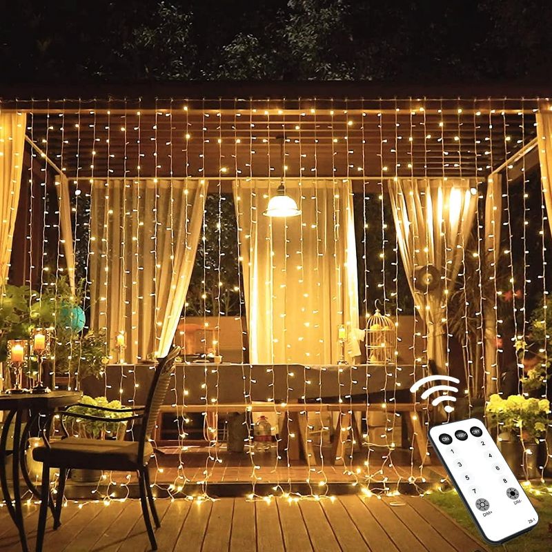 Photo 1 of JMEXSUSS 600 LED Christmas Curtain Lights Outdoor, 9.5x19.6ft Christmas String Light Plug in with Remote, 8 Modes Wall Hanging Lights for Bedroom Party Backdrop Wedding Xmas Decor, Warm White