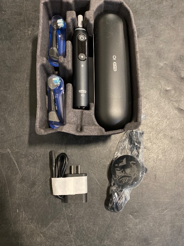 Photo 1 of Oral-B iO Deep Clean + Protect Rechargeable Electric Toothbrush, Black with a iO Series 7 Toothbrush, 2 Replacement Brush Heads, and a Charging Travel Case