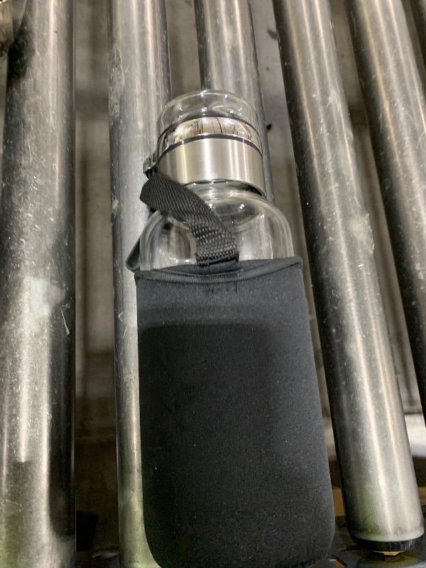 Photo 1 of GLASS WATER BOTTLE 
AND HOLDER 