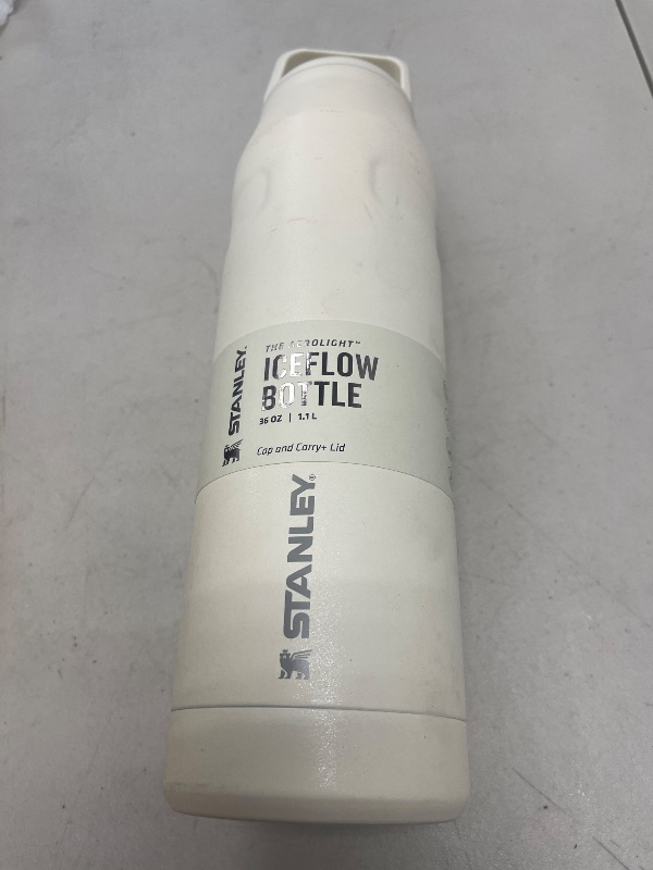 Photo 1 of Stanley IceFlow Cap and Carry Water Bottle 36 oz | Wide Mouth Twist Lid | Lightweight and Leakproof for Travel and Sports | Insulated Stainless Steel | BPA-Free | Cream Glimmer