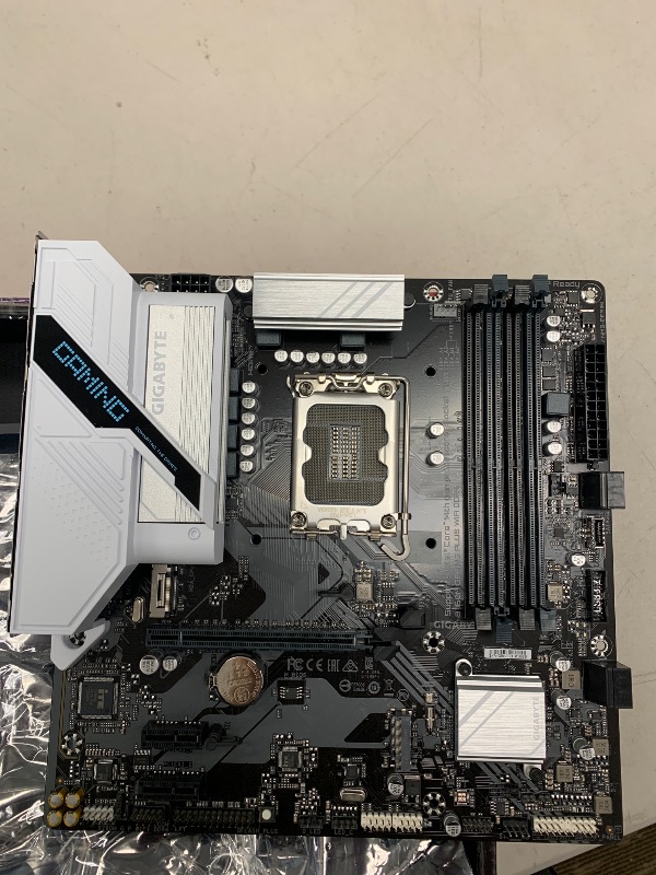 Photo 1 of GIGABYTE B760M Gaming Plus WiFi DDR4 LGA 1700 Intel B760 M-ATX Motherboard with DDR4, 2* M.2, PCIe 4.0, Front USB 3.2 Gen 1 Type-C, WiFi 6 GbE LAN, Q-Flash Plus, PCIe EZ-Latch
