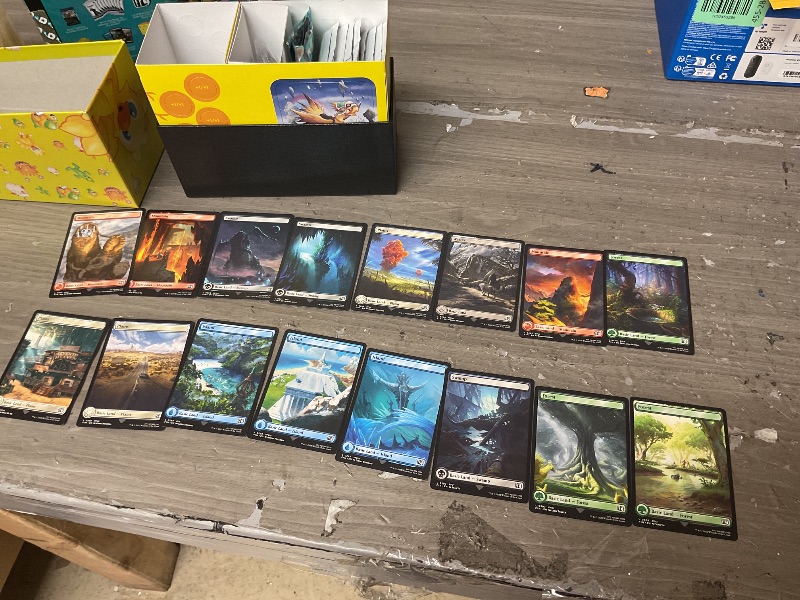 Photo 1 of Magic: The Gathering - Final Fantasy Chocobo Bundle (1 Chocobo Booster, 10 Play Boosters, 1 Alt-Art Promo Card, 1 Scene Card, 32 Basic Lands, 1 Click Wheel, and More)