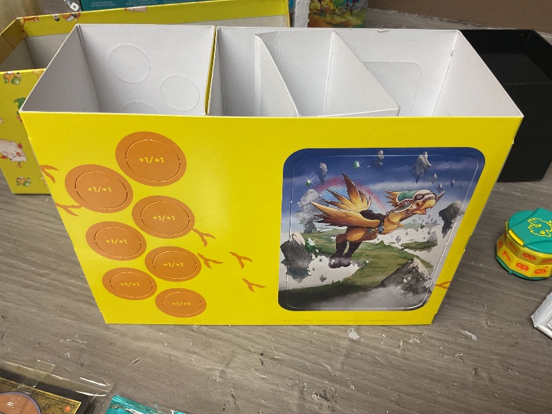 Photo 1 of Magic: The Gathering - Final Fantasy Chocobo Bundle (1 Chocobo Booster, 10 Play Boosters, 1 Alt-Art Promo Card, 1 Scene Card, 32 Basic Lands, 1 Click Wheel, and More)