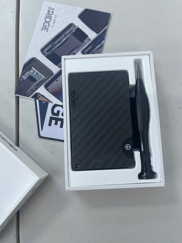 Photo 1 of Ridge Wallet for Men - Slim Minimalist Compact Wallet, RFID Protected Front Pocket Wallets for Men, Integrated Cash Strap Card Holder (Carbon Fiber 3K)
