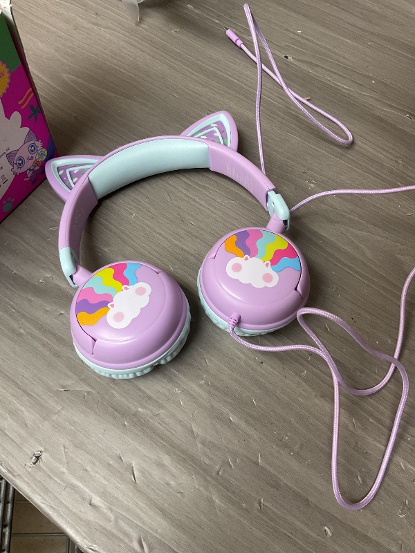 Photo 1 of iClever Kids Headphones USB C, LED Light Up, 85dBA Safe Volume, Stereo Sound Toddler Headphones for Travel School, Kids Headphone with Cord for iPad Tablets, Meow Lollipop-Purple