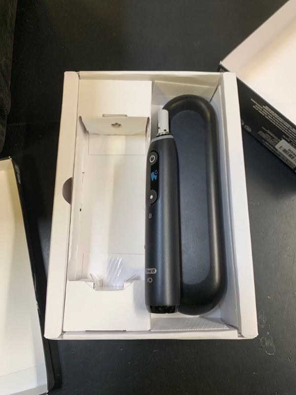 Photo 1 of Oral-B iO Series 10 Rechargeable Electric Toothbrush with Visible Pressure Sensor to Protect Gums, 2 Min Timer, 7 Cleaning Settings, 4 Replacement Toothbrush Heads, and Charging Travel Case, White (parts only) 