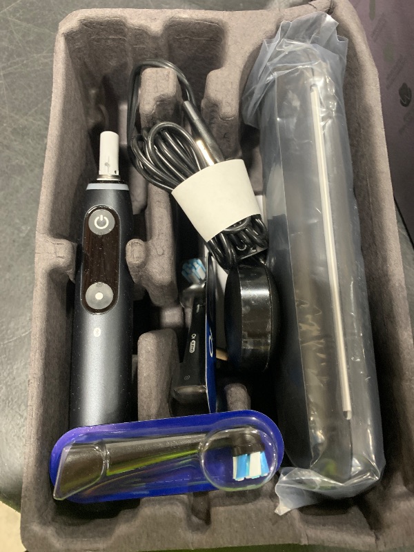 Photo 1 of Oral-B iO Deep Clean + Protect Rechargeable Electric Toothbrush, Black with a iO Series 7 Toothbrush, 2 Replacement Brush Heads, and a Charging Travel Case
