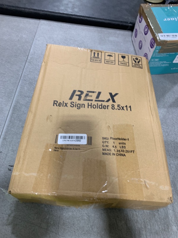 Photo 1 of Relx Sign Holder Stand 8.5x11 inch - Adjustable Floor Standing Sign Holder - Signage Stand with Snap-Open Frame Display for Malls,Schools,Restaurants