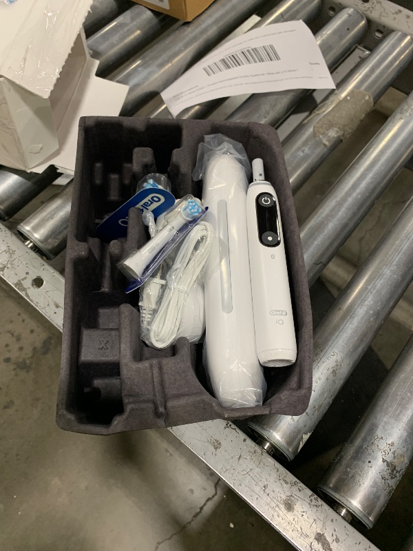 Photo 1 of Oral-B iO Deep Clean + Protect Rechargeable Electric Toothbrush, White with a iO Series 7 Toothbrush, 2 Replacement Brush Heads, and a Charging Travel Case