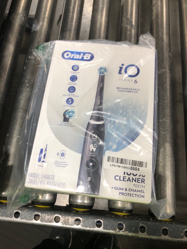 Photo 1 of Oral-B iO Series 6 Rechargeable Electric Toothbrush with Visible Pressure Sensor to Protect Gums, 2 Minute Timer, 5 Cleaning Settings, 1 Replacement Toothbrush Head, and Travel Case, Black