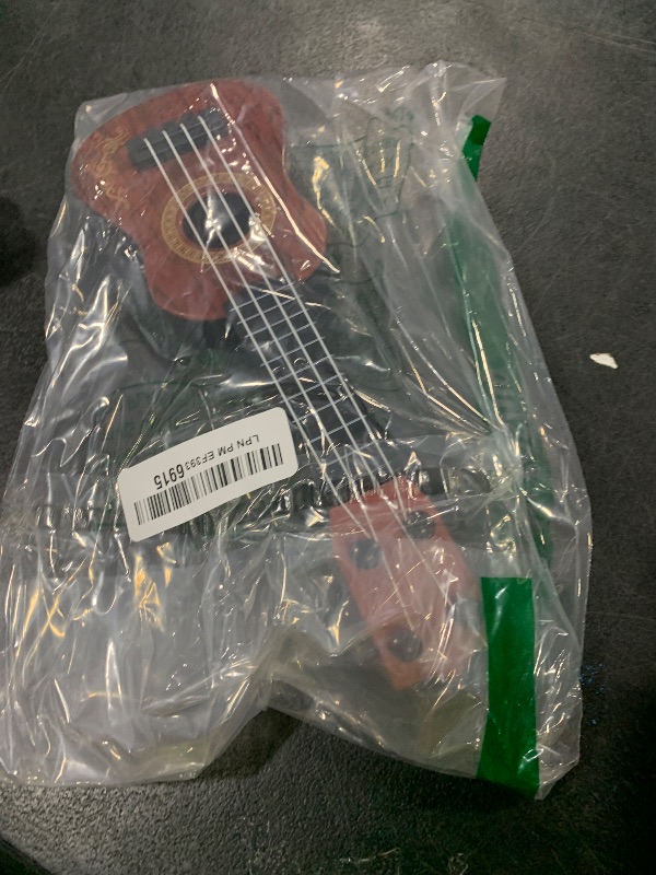 Photo 1 of Toddmomy Melodic Fun for Kids: Plastic Ukulele Guitar - A Musical Toy Instrument for Children, Inspiring Musical Education and Playful Exploration