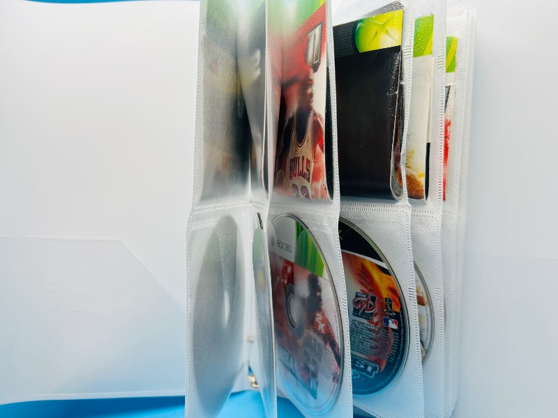 Photo 1 of 593355…10 XBOX and Wii sports game discs in binder-see photos 