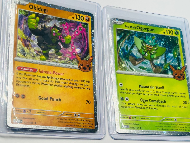 Photo 1 of 593440…3 holo trick or trade Pokémon cards in hard plastic sleeves 