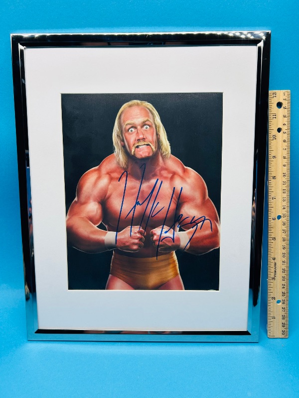 Photo 1 of 593449…..autographed Hulk Hogan picture with certification sticker 14 x 12 “ approx