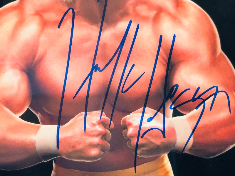 Photo 1 of 593449…..autographed Hulk Hogan picture with certification sticker 14 x 12 “ approx