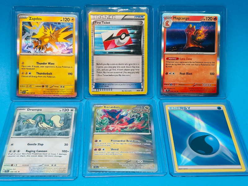 Photo 1 of 593572… 6 holo Pokémon card in hard plastic sleeves 