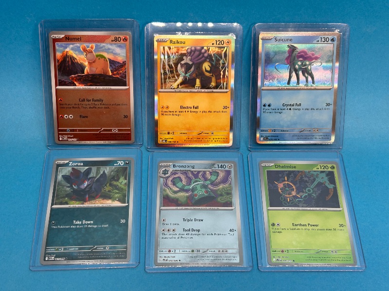 Photo 1 of 594085…6 reverse and holo Pokémon cards in hard plastic sleeves